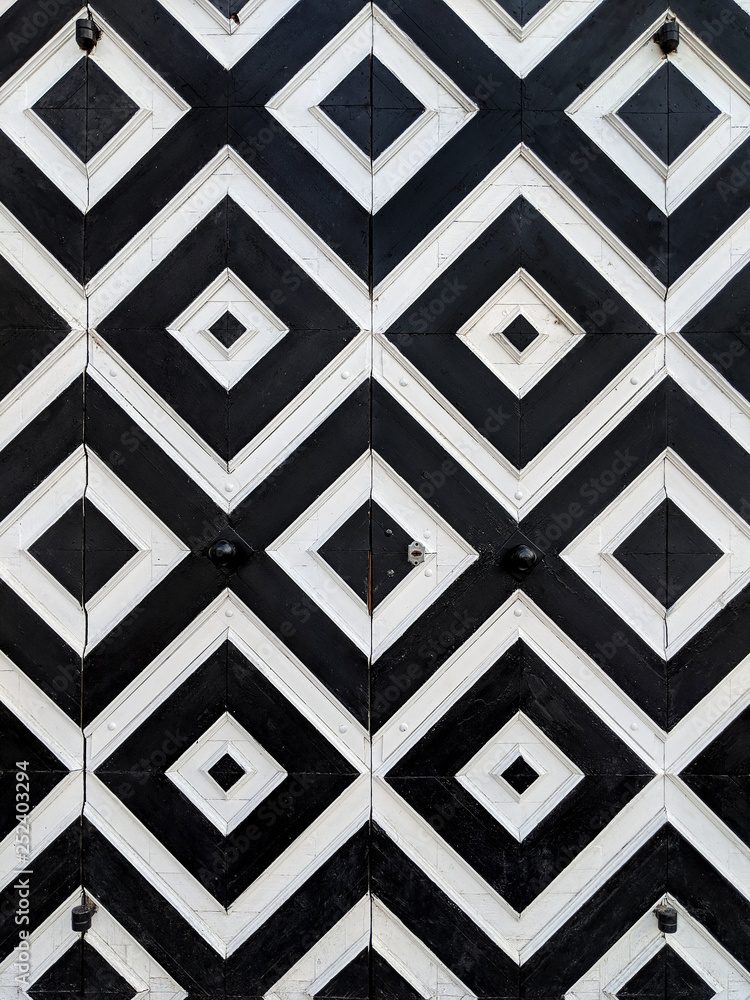 wooden door with a black and white pattern wooden door with a black and white pattern