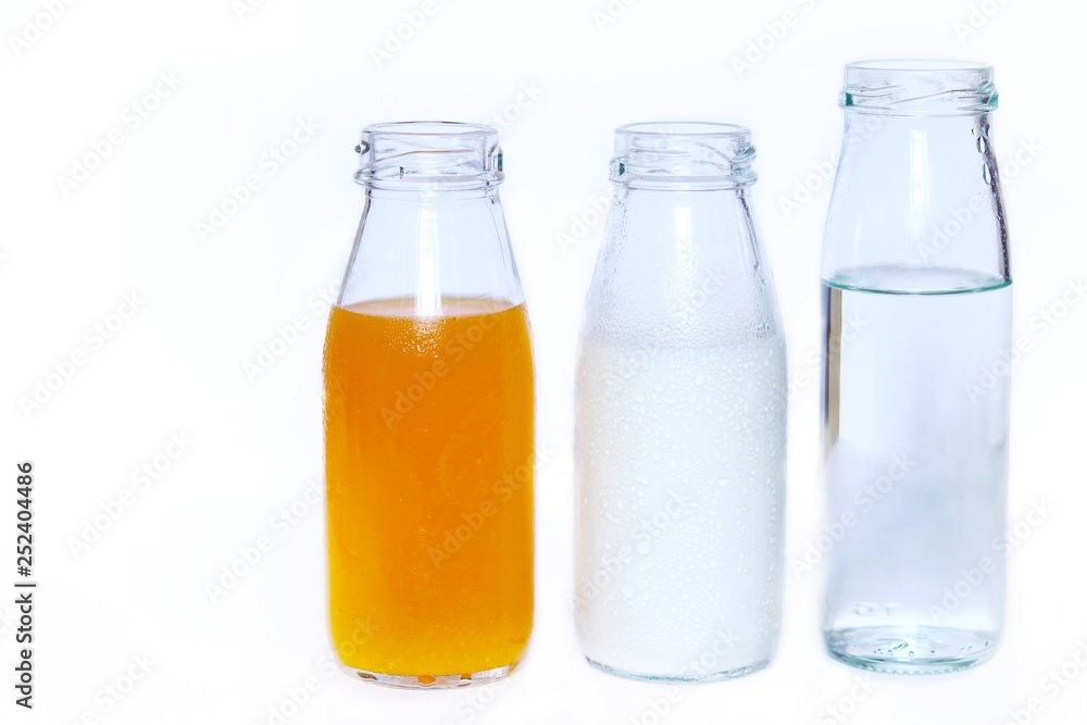 The set of bottles of orange juice,milk and drink water isolated on white background , Healthy concept The set of bottles of orange juice,milk and drink water isolated on white background , Healthy concept