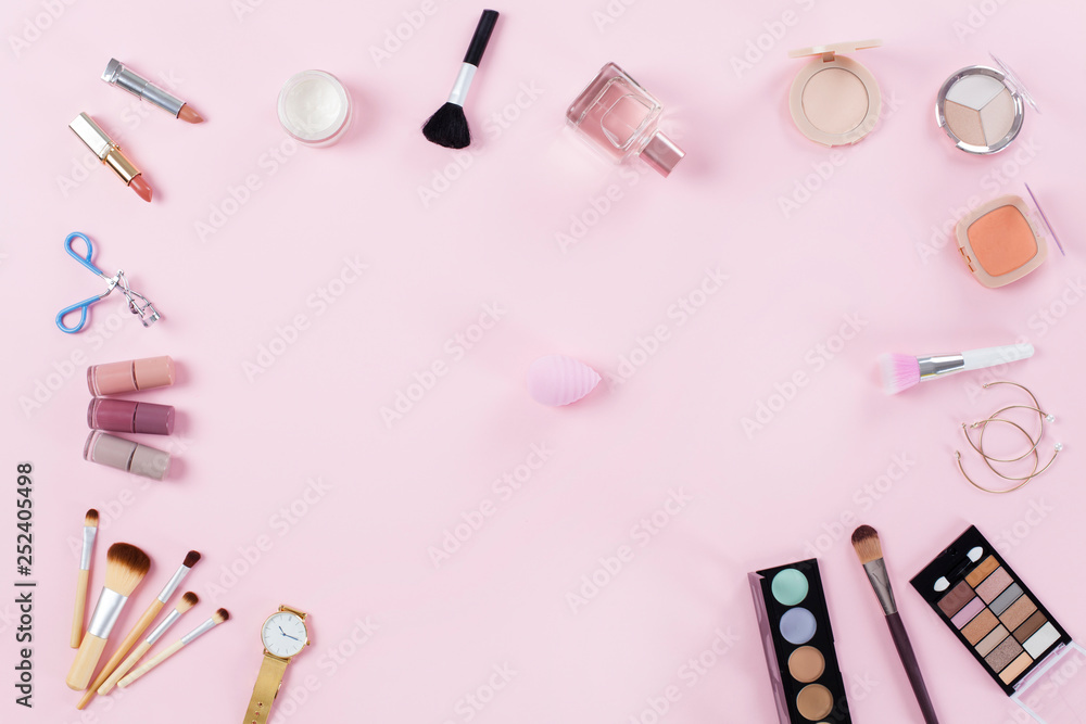 Makeup products frame on a pink background Makeup products frame on a pink background
