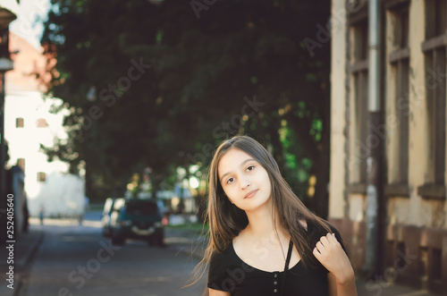 Cute young girl without makeup on the background of a beautiful old building. © natavilman