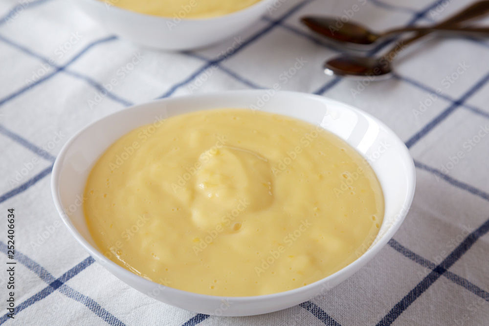 Homemade vanilla custard pudding on cloth, side view. Close-up. Homemade vanilla custard pudding on cloth, side view. Close-up.
