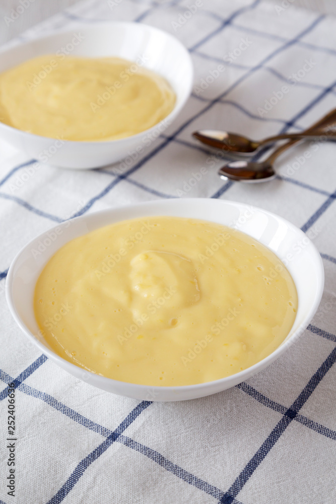 Side view, homemade vanilla custard pudding on cloth. Closeup. Side view, homemade vanilla custard pudding on cloth. Closeup.
