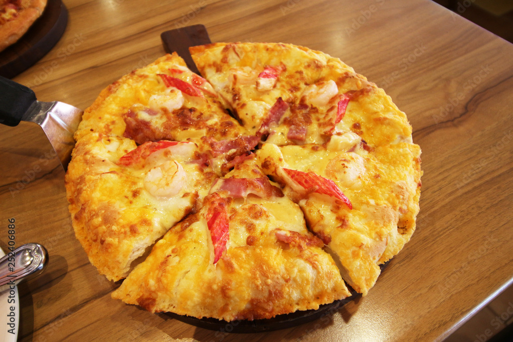 pizza served at restaurant on handled wooden board