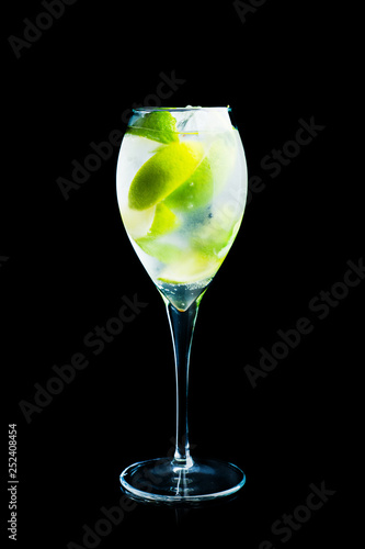 Royal mojito cocktail lime and mint isolated on black background. Selective focus. Shallow depth of field.