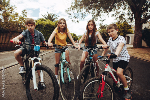 Boys and girls on bicycles in a street