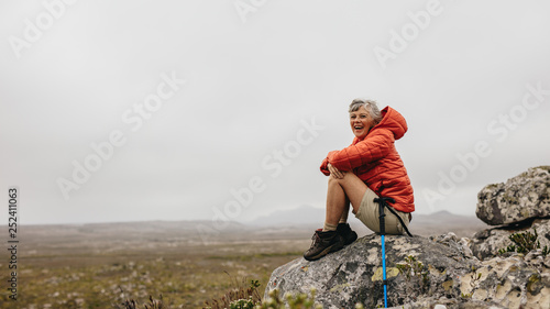 Cheerful senior woman enjoying her hiking trip