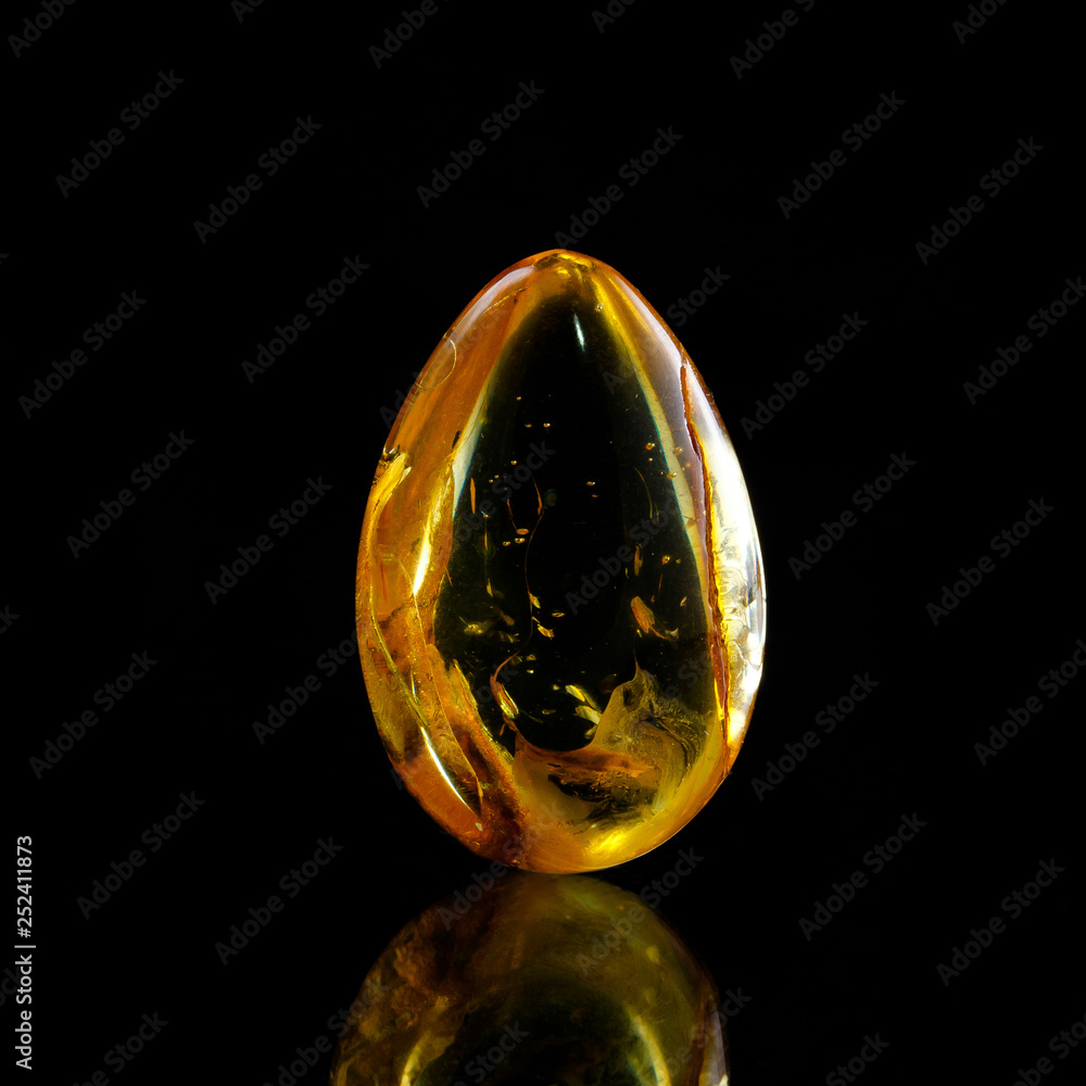 A unique piece of solar amber on a black background.
