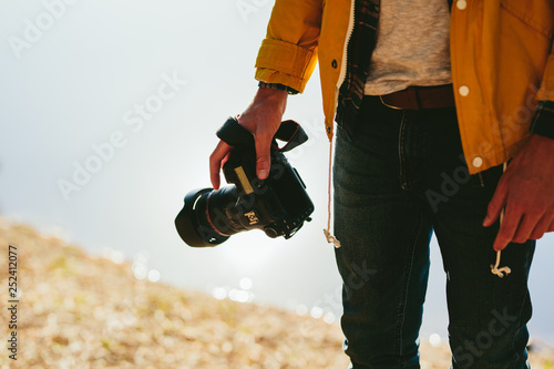 Close up of a photographer holding his dslr camera