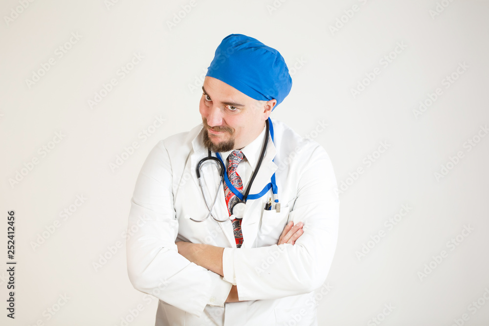 The doctor smiles with his arms folded. Close-up The doctor smiles with his arms folded. Close-up