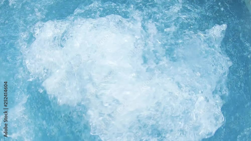 Splash water slow motion big bubbles in warm water in pool in a mountain resort luxury hotel. Hydroterrapy. Strong water pressure in the spa salon. The texture of boiling water. Relax. Tourism. Gopro Splash water slow motion big bubbles in warm water in pool in a mountain resort luxury hotel. Hydroterrapy. Strong water pressure in the spa salon. The texture of boiling water. Relax. Tourism. Gopro