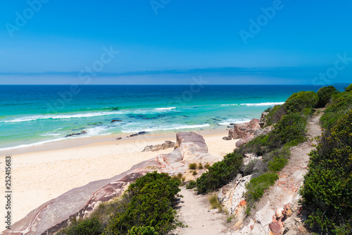 View over remote Quondolo Beach, located in Ben Boyd National Park, NSW, Australia, popular for surfing and rockpool exploring and subject to rips tides and big waves © stanciuc