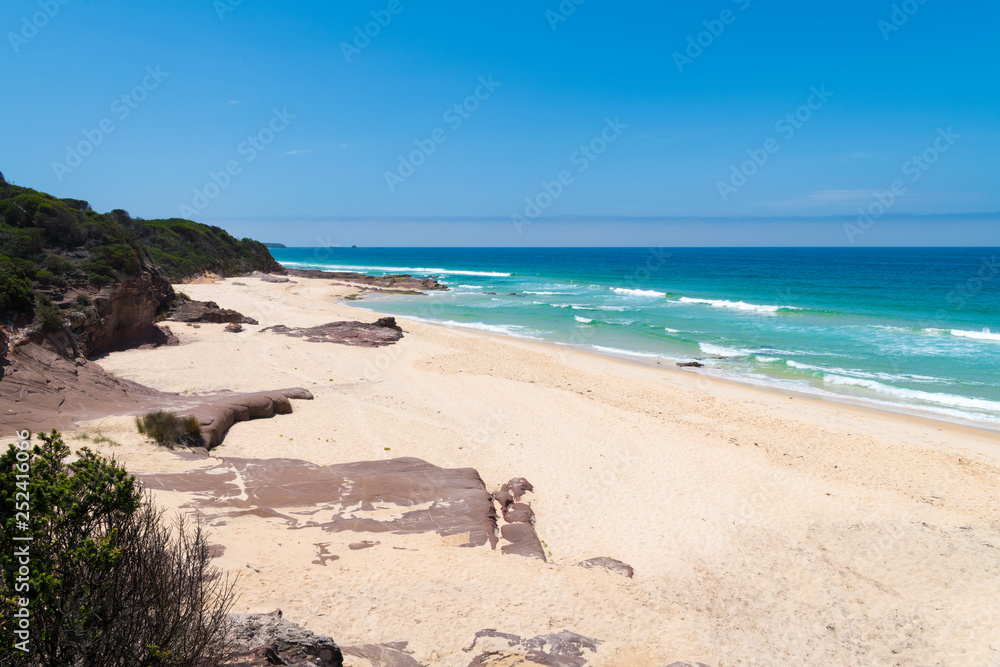 View over remote Quondolo Beach, located in Ben Boyd National Park, NSW, Australia, popular for surfing and rockpool exploring and subject to rips tides and big waves View over remote Quondolo Beach, located in Ben Boyd National Park, NSW, Australia, popular for surfing and rockpool exploring and subject to rips tides and big waves