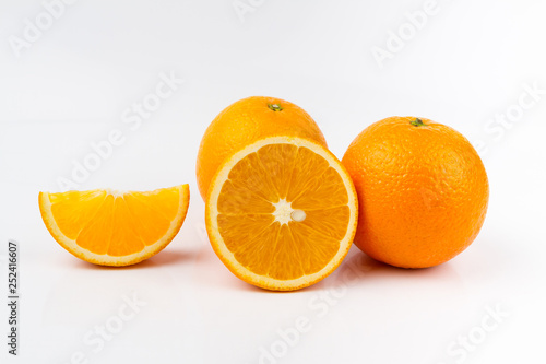 Ripe orange fruit on white background. Round orange slice.
