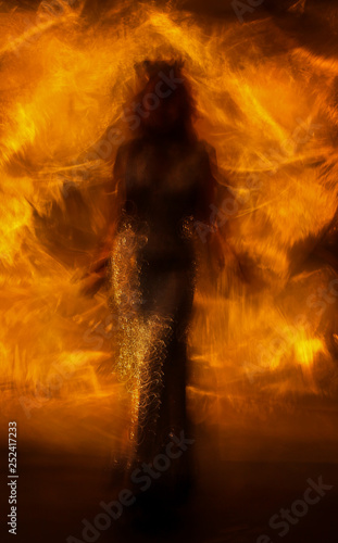 the silhouette of the queen on fire
