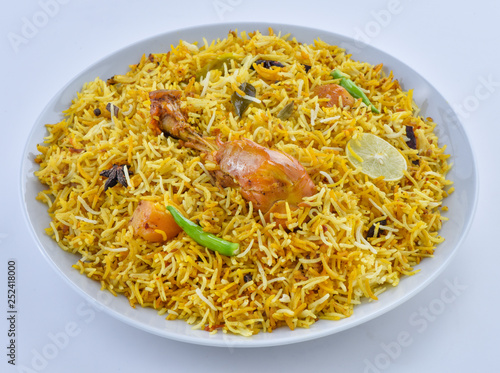 Chicken Biryani, a yummy & fluffy rice dish with spicy savory chicken pieces with salad. photo