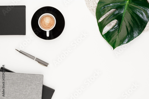  coffee cab pen notepad plant monstera bowl office top view with copy space for your text. flat lay. 