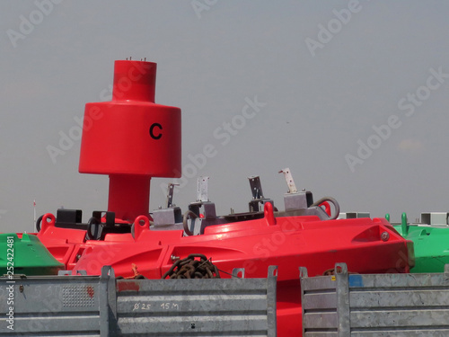 red buoy with the letter C on it in the harbor of Antwerp