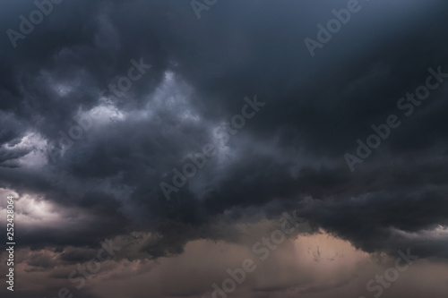 Scary epic sky with menacing clouds. Hurricane wind with a thunderstorm. Stock background, photo