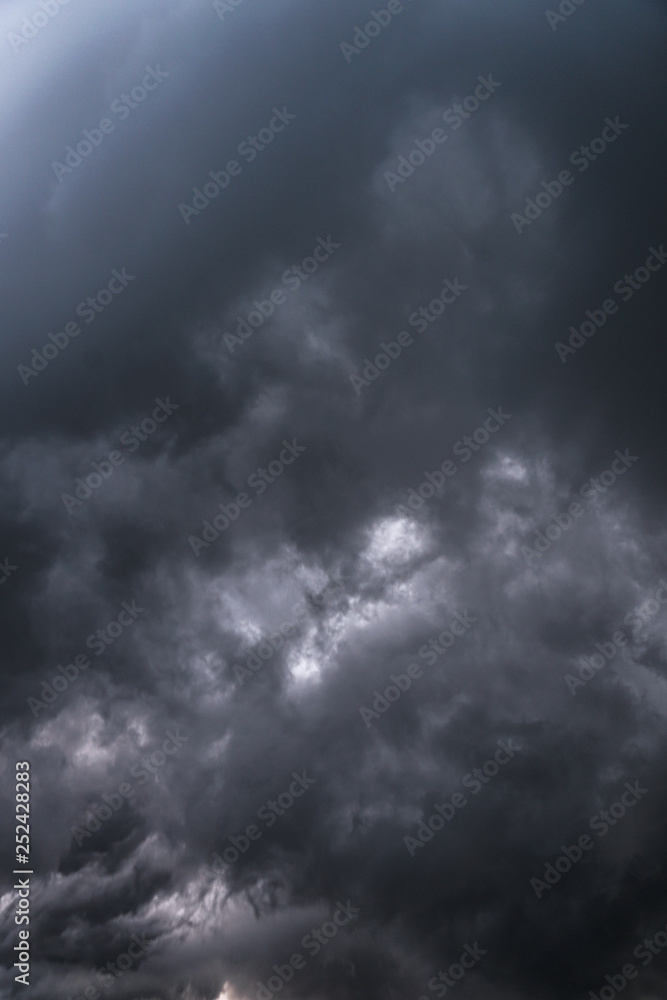 Scary epic sky with menacing clouds. Hurricane wind with a thunderstorm. Stock background, photo