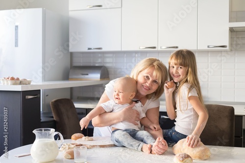 Grandmother, granddaughter and grandson, kitchen