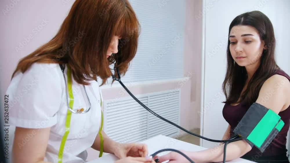 Medical clinic. Doctor measures patient pressure Medical clinic. Doctor measures patient pressure