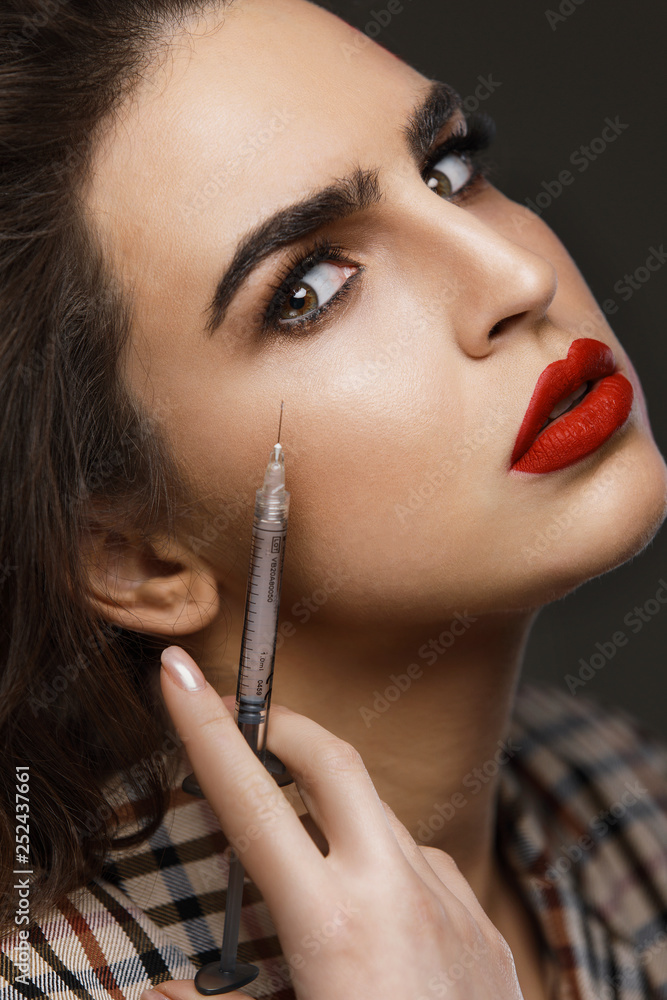 Woman getting face lifting injection in her skin Woman getting face lifting injection in her skin