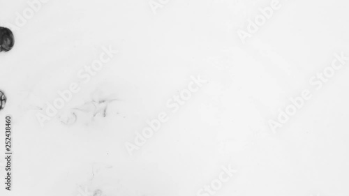 Top view, the chaotic falling of black paint droplets. Abstract