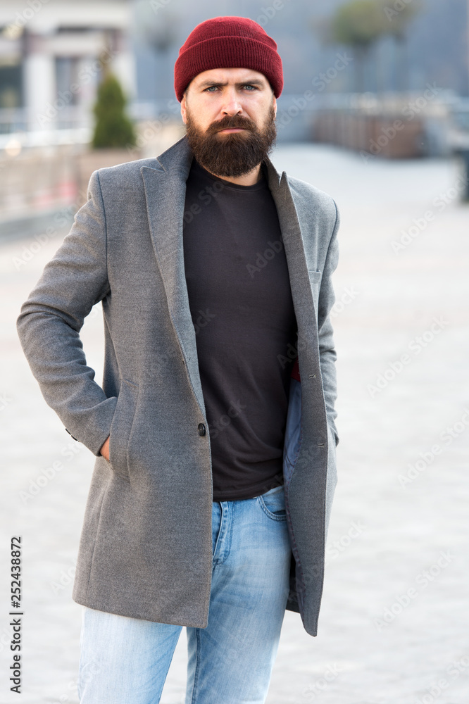 Lumbersexual style. Hipster outfit and hat accessory. Stylish casual outfit spring season. Menswear and male fashion concept. Man bearded hipster stylish fashionable coat and hat. Comfortable outfit