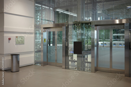 Indoor view of empty clean entrance in international airport terminal with stylish modern automatic transparent glass doors. Urban lifestyle  interior  construction  architecture and design concept