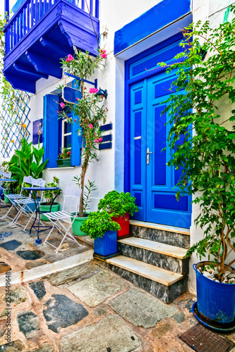Fototapeta Naklejka Na Ścianę i Meble -  Traditional narrow streets with cute cafe bars in Greece. Skopelos island, Sporades