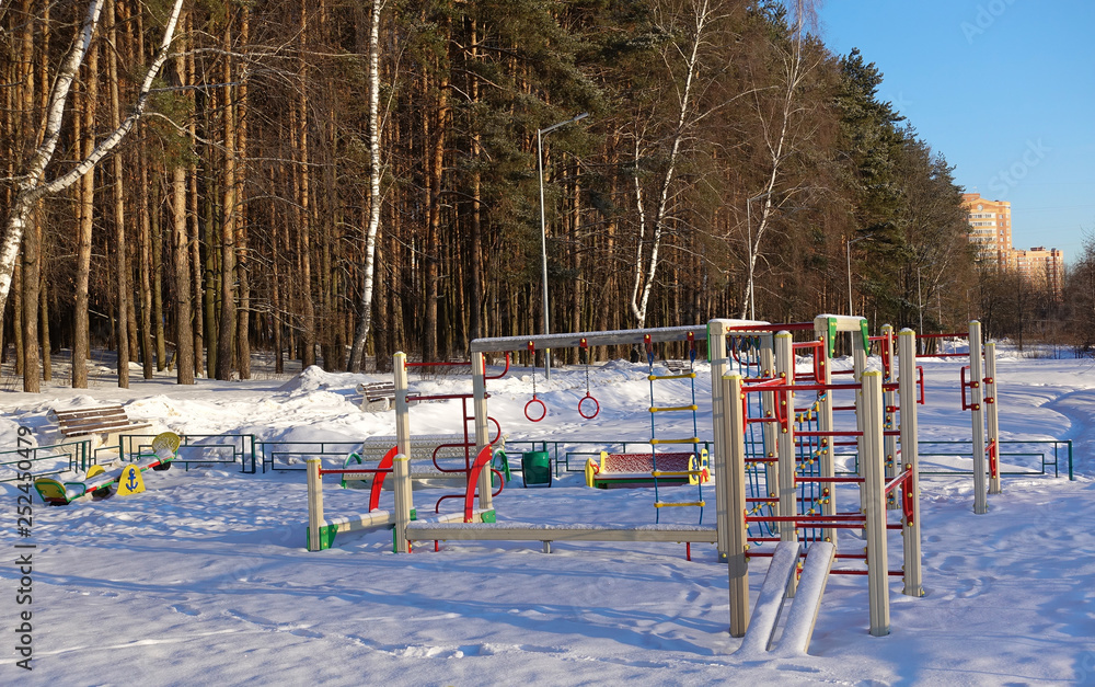 Empty playground for children on a frosty snowy winter day covered with snow without people. Russian playground. Maritime military theme. Raising children in the military spirit. Empty playground for children on a frosty snowy winter day covered with snow without people. Russian playground. Maritime military theme. Raising children in the military spirit.