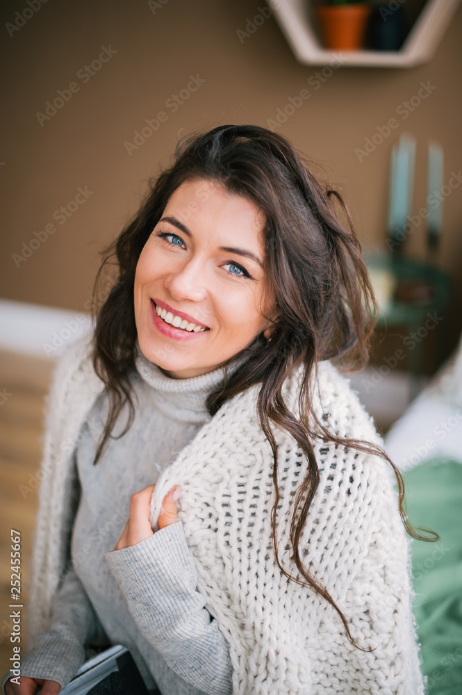 Portrait of beautiful woman in scarf smiling to camera at home Portrait of beautiful woman in scarf smiling to camera at home