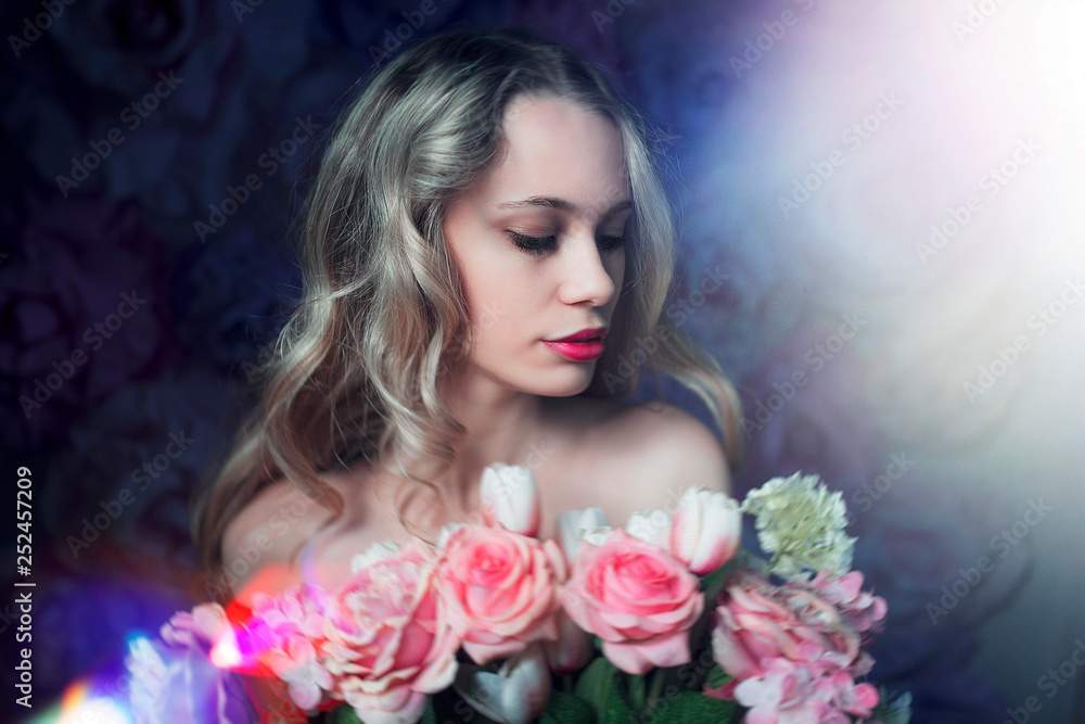 beautiful woman with long blonde hair and red lips posing with bouquet of pink roses on the tender background of flowers in studio beautiful woman with long blonde hair and red lips posing with bouquet of pink roses on the tender background of flowers in studio