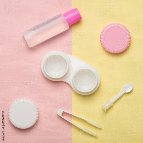 Accessories for contact lenses on a multicolored background. The view from the top.
