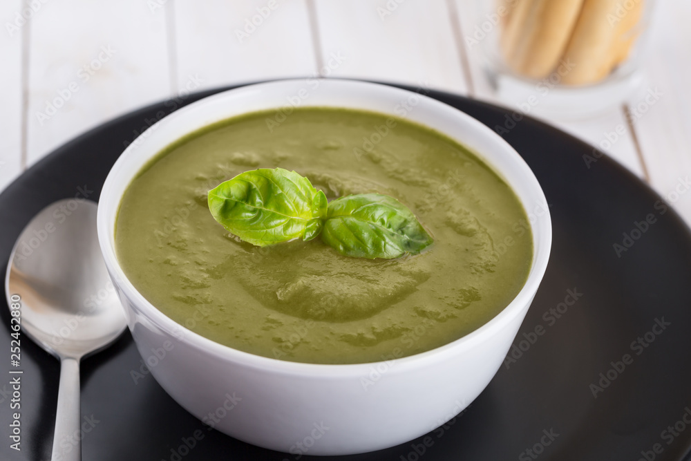 Green cream soup of spinach and chickpeas on concrete wood background Green cream soup of spinach and chickpeas on concrete wood background