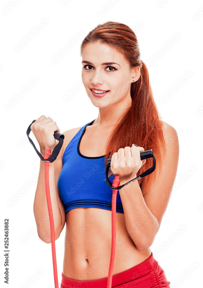 Portrait of beautiful smiling fitness woman training with expander Portrait of beautiful smiling fitness woman training with expander