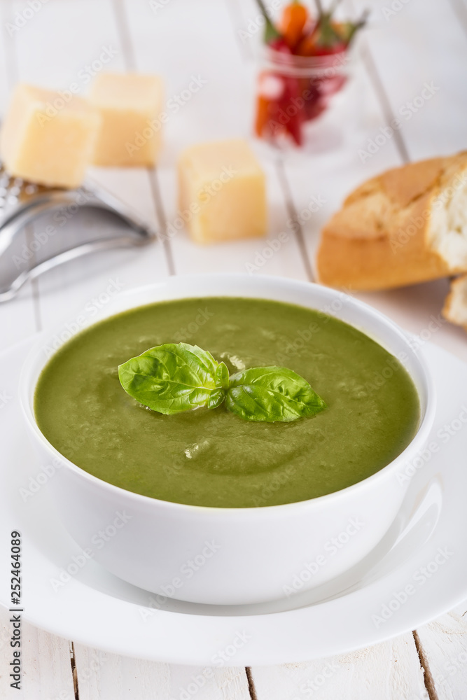 Green cream soup of spinach and chickpeas on concrete wood background Green cream soup of spinach and chickpeas on concrete wood background