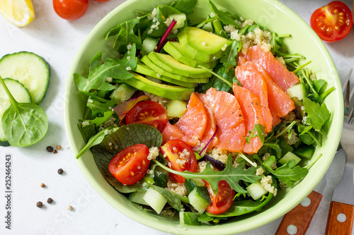 Diet menu concept. Summer Healthy salad with quinoa, Tomatoes, Salmon, Avocado and arugula.