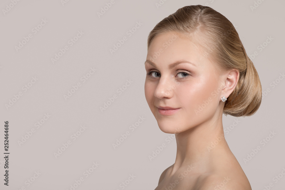Young woman with hairstyle bun. Clean skin and hair concept Young woman with hairstyle bun. Clean skin and hair concept