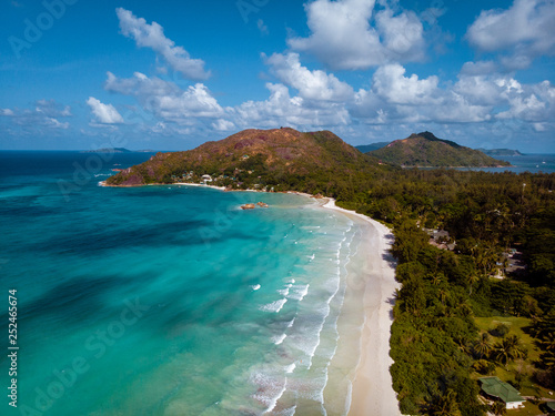 Praslin Island Seychelles drone view from aboven out the sky, People relax and snorkling by the white beach with palm trees photo