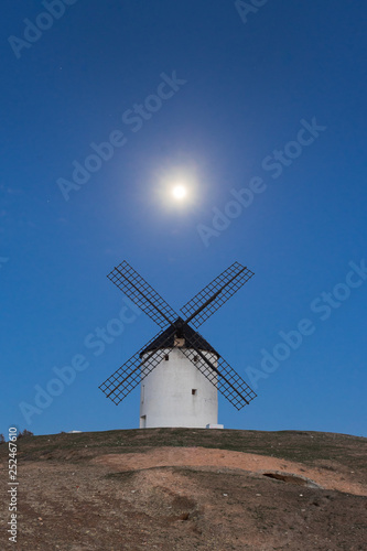 Typical windmill in with the moon at the background