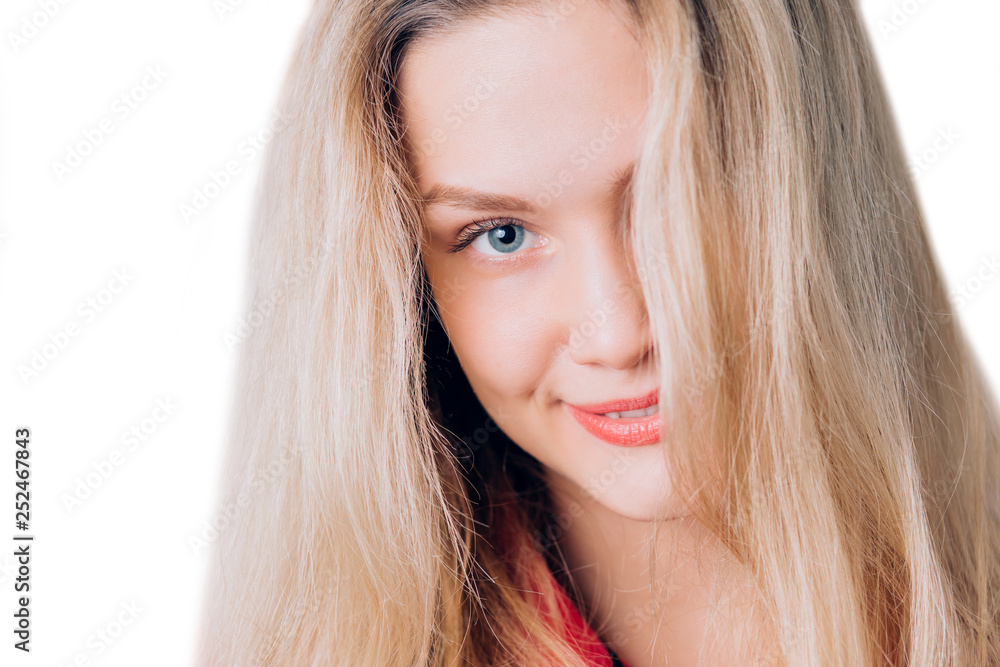 Closeup portrait of cute blonde woman with long hair, clean skin, natural makeup, and white teeth. Expressive beautiful blue eyes looking at the camera. Closeup portrait of cute blonde woman with long hair, clean skin, natural makeup, and white teeth. Expressive beautiful blue eyes looking at the camera.
