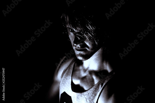 Half-profile of the upper part of the figure of a young man in the dark