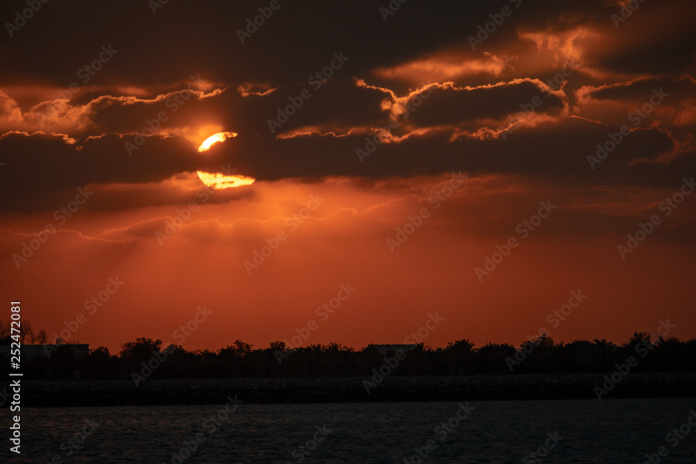 Fototapeta premium Dramaitc sunset and sunrays peaking through clouds