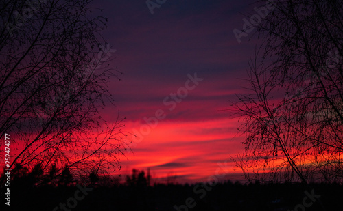 A dramatic and colorful cloudy sunset sky is photographed over Lithuania
