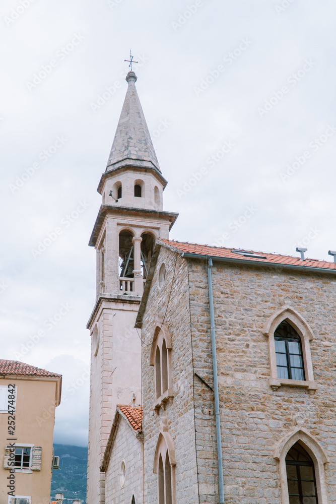 old european church with narrow tower and bell