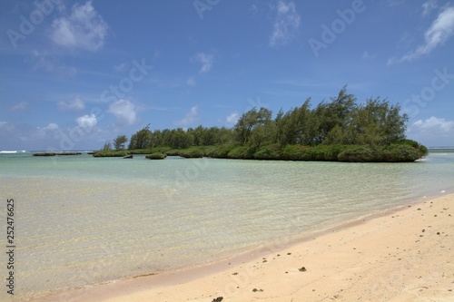 Fototapeta Naklejka Na Ścianę i Meble -  One of the beautiful beaches with a green rocky island at the southern part of Guam, United States