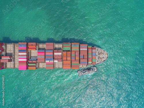 Aerial top view container ship going to sea port or container warehouse for unload container. Logistics, import export, shipping or transportation.