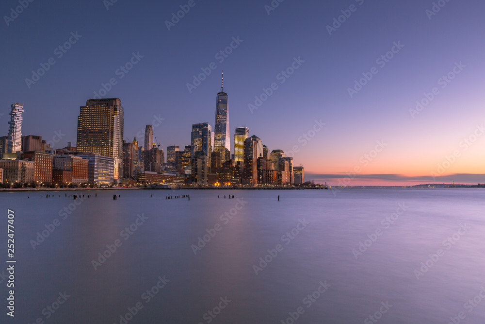 View on Financial District from Hudson river at twilight with long exposure