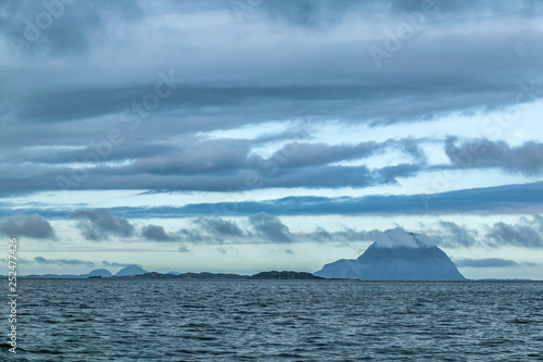 sea and landscape with steep mountains and dramatic cloud sky in the  fords of middle Norway  Scandinavia